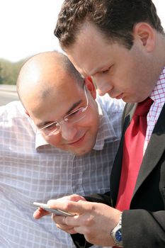 two businessman by mobile phone