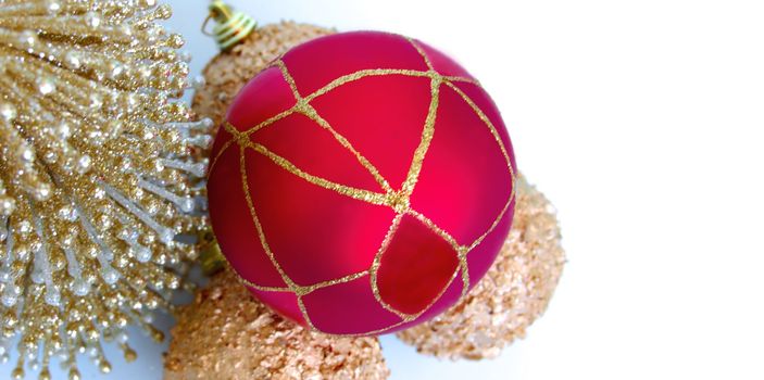 christmas decorations, shiny gold sphere and red garland