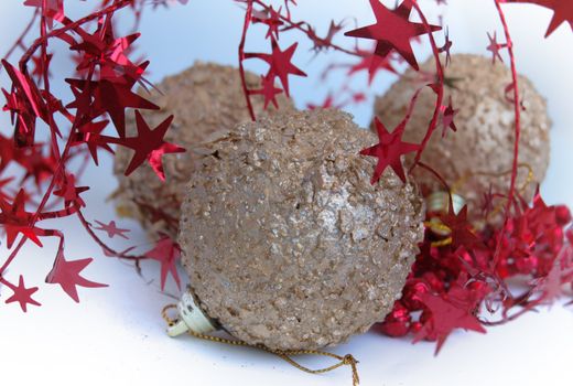 christmas decorations, shiny gold sphere and red garland