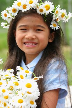 Beautiful little girl with crown of daisies