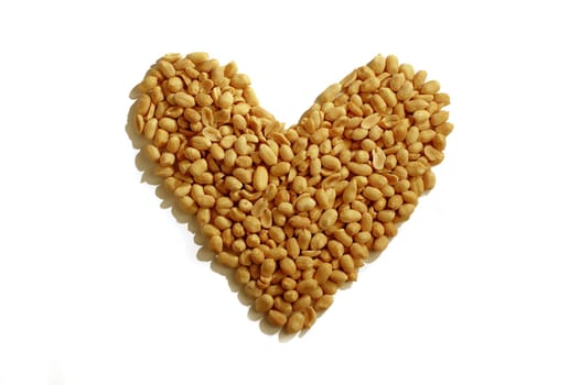 Peanuts forming heart symbol on white background.