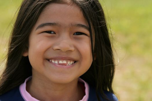 Smiling asian girl with toothy smile