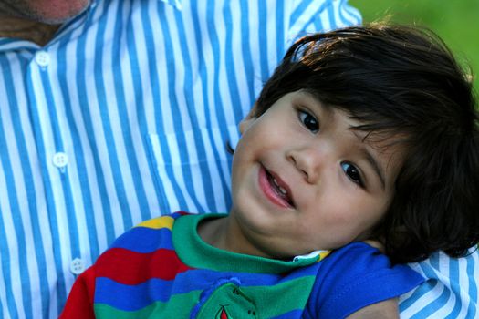 Happy toddler in father;s arms