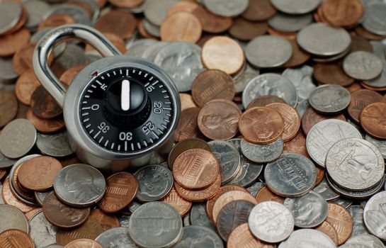 Combination lock on coins background.