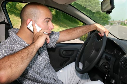 Young adult hold mobil phone during driving