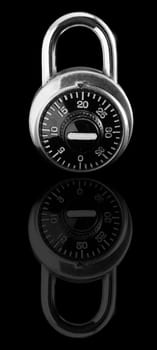 Combination lock on black background with reflection.