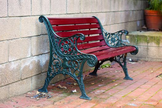 Iron and Wood Garden Bench painted Green and Red, with small depth of field