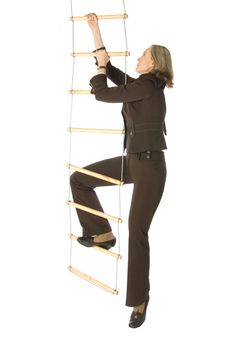 An isolated photo of a businesswoman climbing a rope-ladder