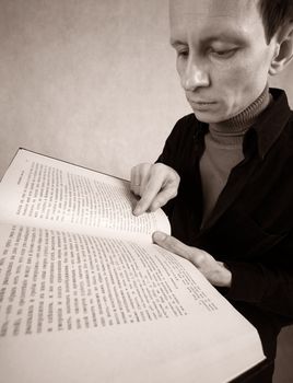 The adult man with the open book