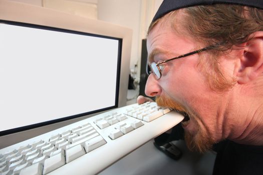 mad programmer sitting at a computer desk