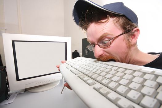 mad programmer sitting at a computer desk