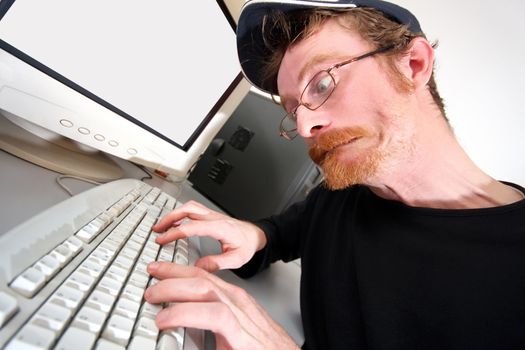 mad programmer sitting at a computer desk