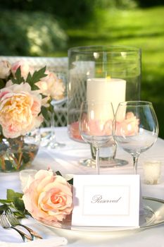 Place setting and card on a table at a wedding reception 