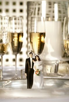 Wedding cake figurines on plate at dinner reception