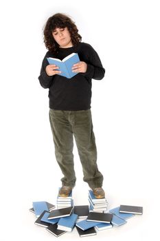 boy on stack of books on white background