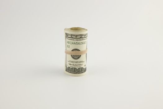 A roll of United States hundred dollar bills
