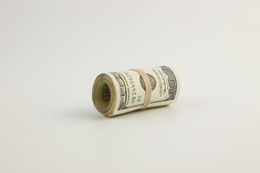 A roll of United States hundred dollar bills
