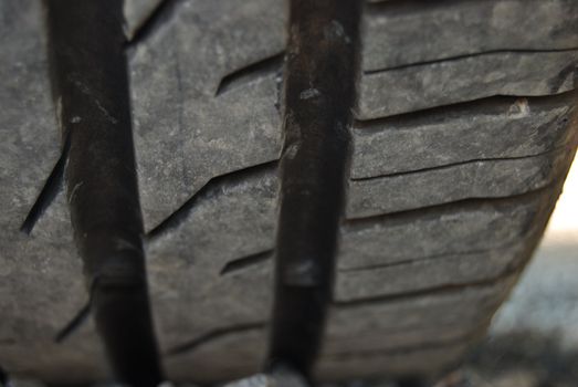 closeup of a car tire profile (car parked on pebbles)