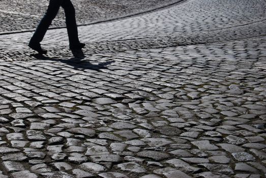 tourist walking up the cobblestone pavement of Edinburgh castle