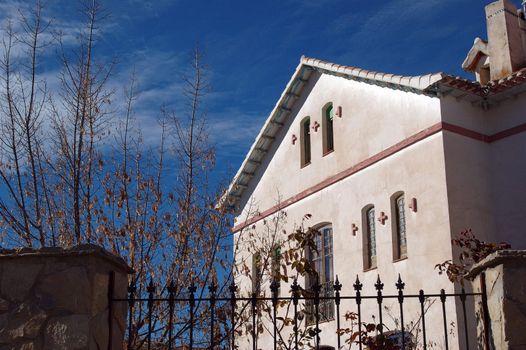 Village house with iron fence