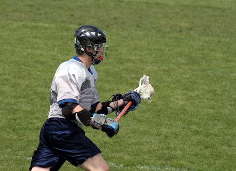 A lacrosse player charges up the field.
