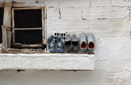 Detail of a window with old shoes
