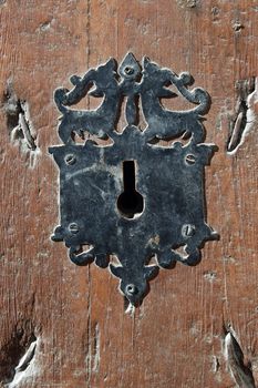 Details of a door lock of brown with ornamental iron