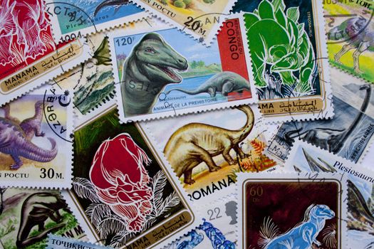 A collection of dinosaurs stamps from different countries, such as Congo, England, Romania, Bahrain and others