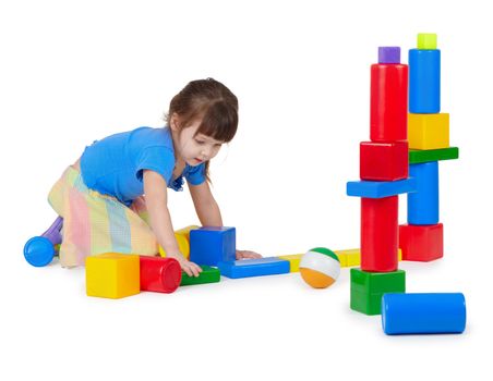 Girl playing toy bricks on white background
