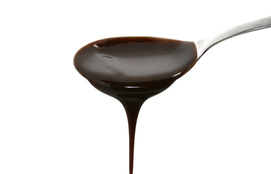 chocolate syrup on a spoon