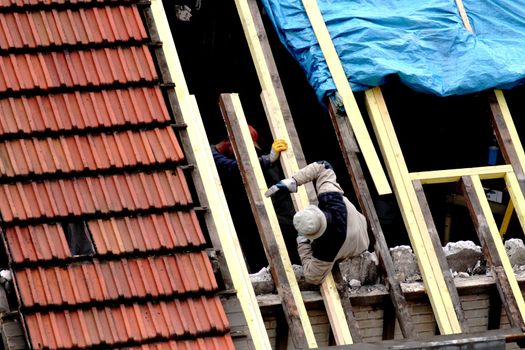Carpenters working on the roof of a house