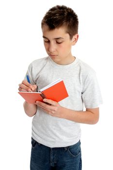 A boy or student writing in a book with a pen.