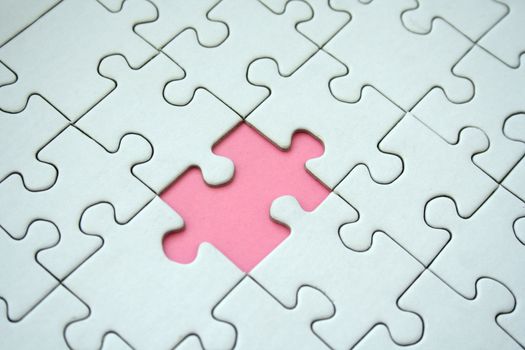 White jigsaw pattern with one empty pink element