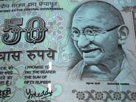 Closeup of fifty rupee bill / note with Gandhi emblem.