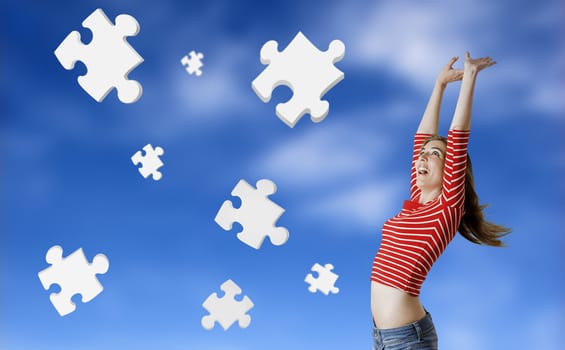 Beautiful woman happy with the solutions for her problems - Concept with 3d puzzle pieces floating in the sky