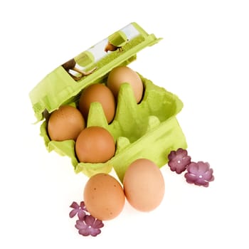 four eggs in a green box and two eggs in the front