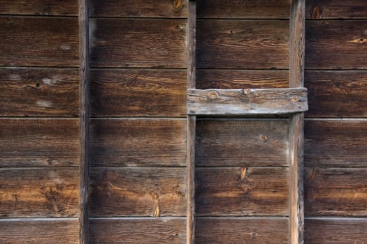 old barn wall with verical posts - weathered wood background with grid pattern