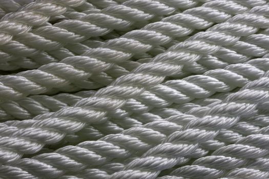 texture of white, nylon, anchor rope in coils - background
