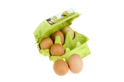 four eggs in a green box and two in front of the box