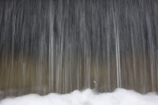 falling water with sprays and foam in blurred motion due to slwo shutter speed