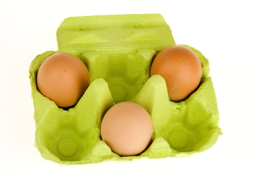 three eggs in a green box