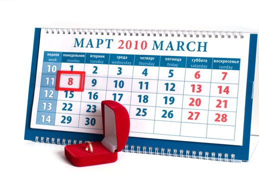 Calendar with date on March, 8th and a red box with a gold ring.