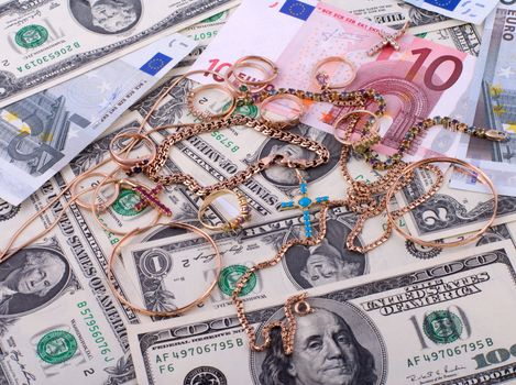 The background of the bills of dollars and euros and jewelry.