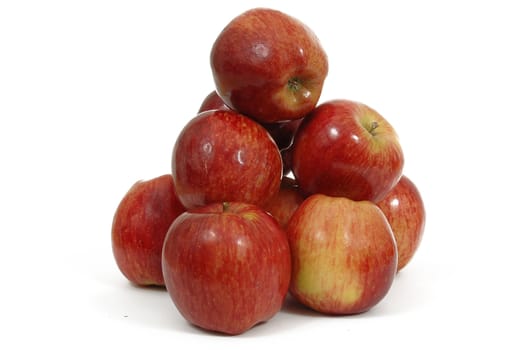 Red appels on white background. The appels are piled up.