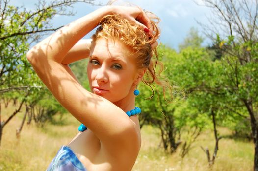 sensual redhead girl with diadem on nature background