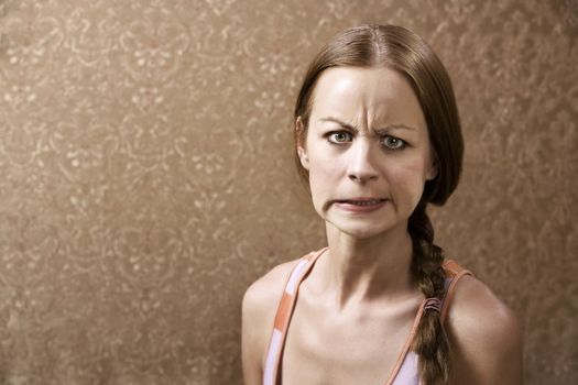 Angry Young Woman in front of Gold wallpaper