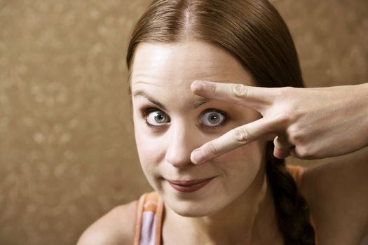 Funny Woman Peeking Out From Between Her Fingers