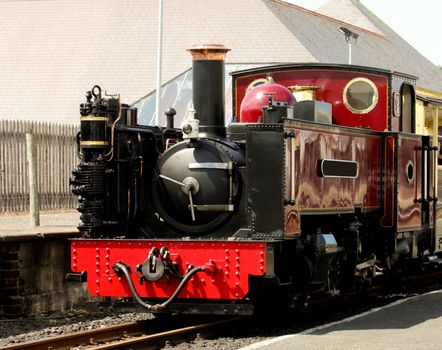 Red and black steam train in station at Aberystwyth Wales UK
