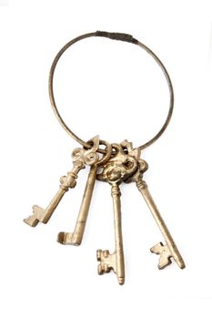 Antique golden keyring with four keys isolated on white background