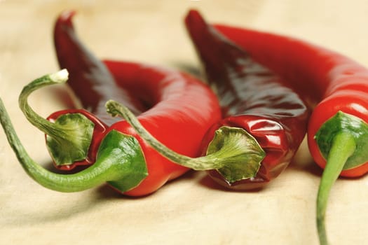 Macro shot of red hot chilli peppers on a cutting board